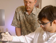 Hud and graduate student Swapan Jain freeze samples in liquid nitrogen